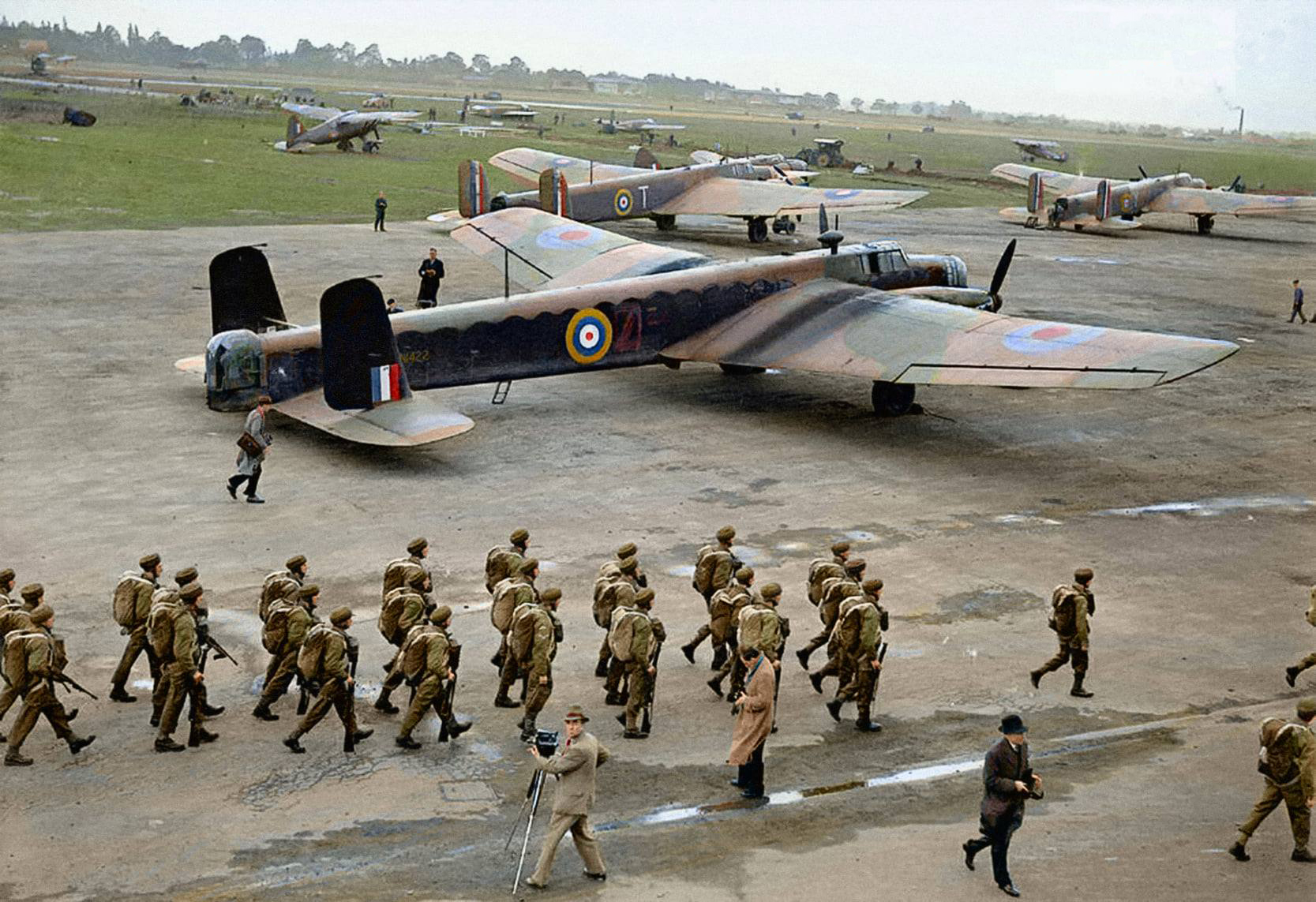 Wartime image of troops at RAF Ringway, marching past Armstrong Whitworth Whitley aircraft on the dispersal.